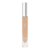 The Tiny Finch Macrene Actives high performance concealer in Extra Deep shade with a silver cap and clear tube.