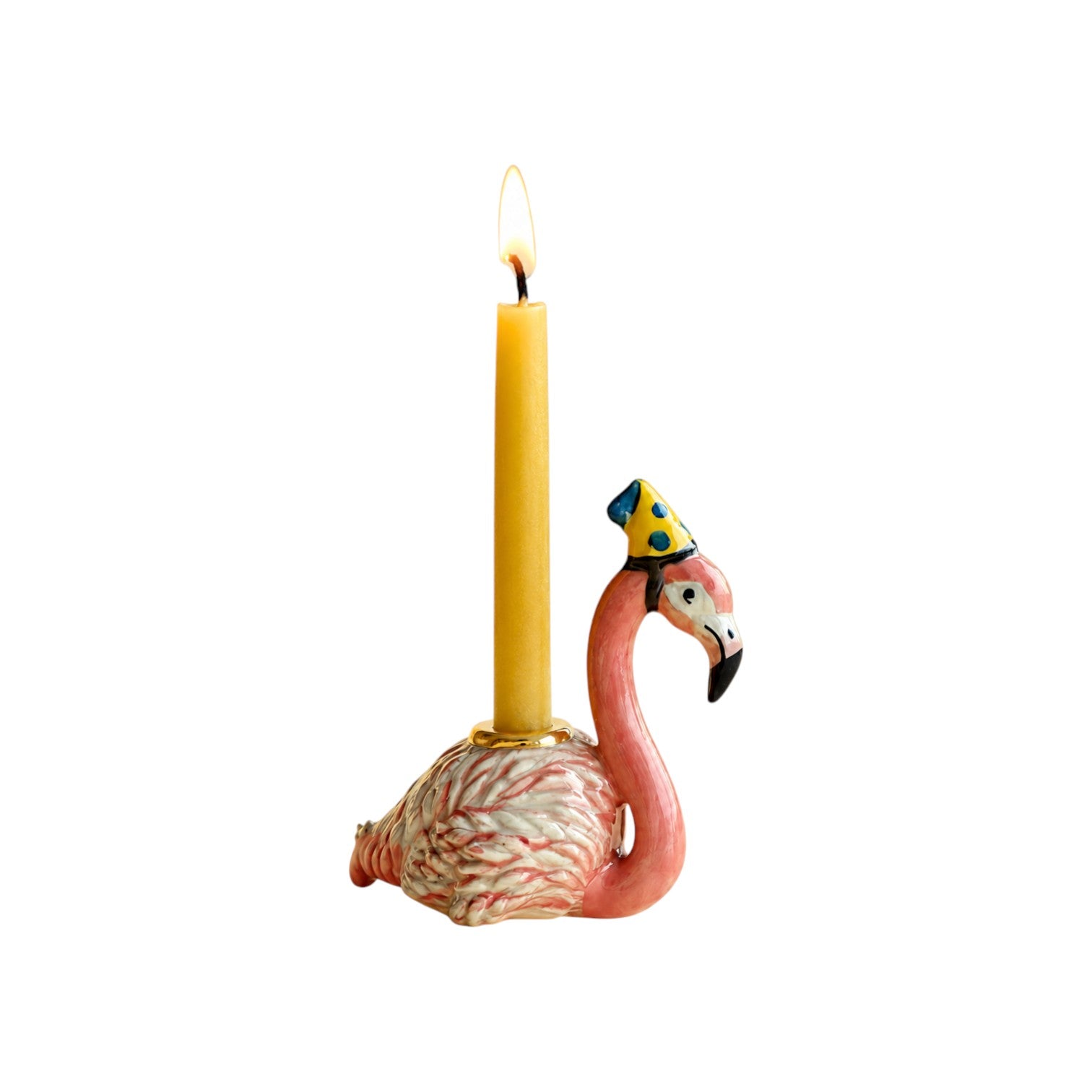 The Tiny Finch porcelain flamingo cake topper with fuchsia feathers, a yellow party hat, and a lit birthday candle.