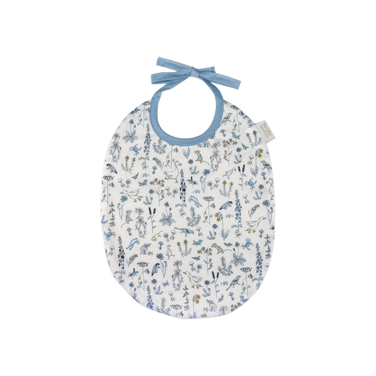 The Tiny Finch Bib Gus featuring a delicate blue and yellow floral Liberty fabric with a soft blue ribbon tie.