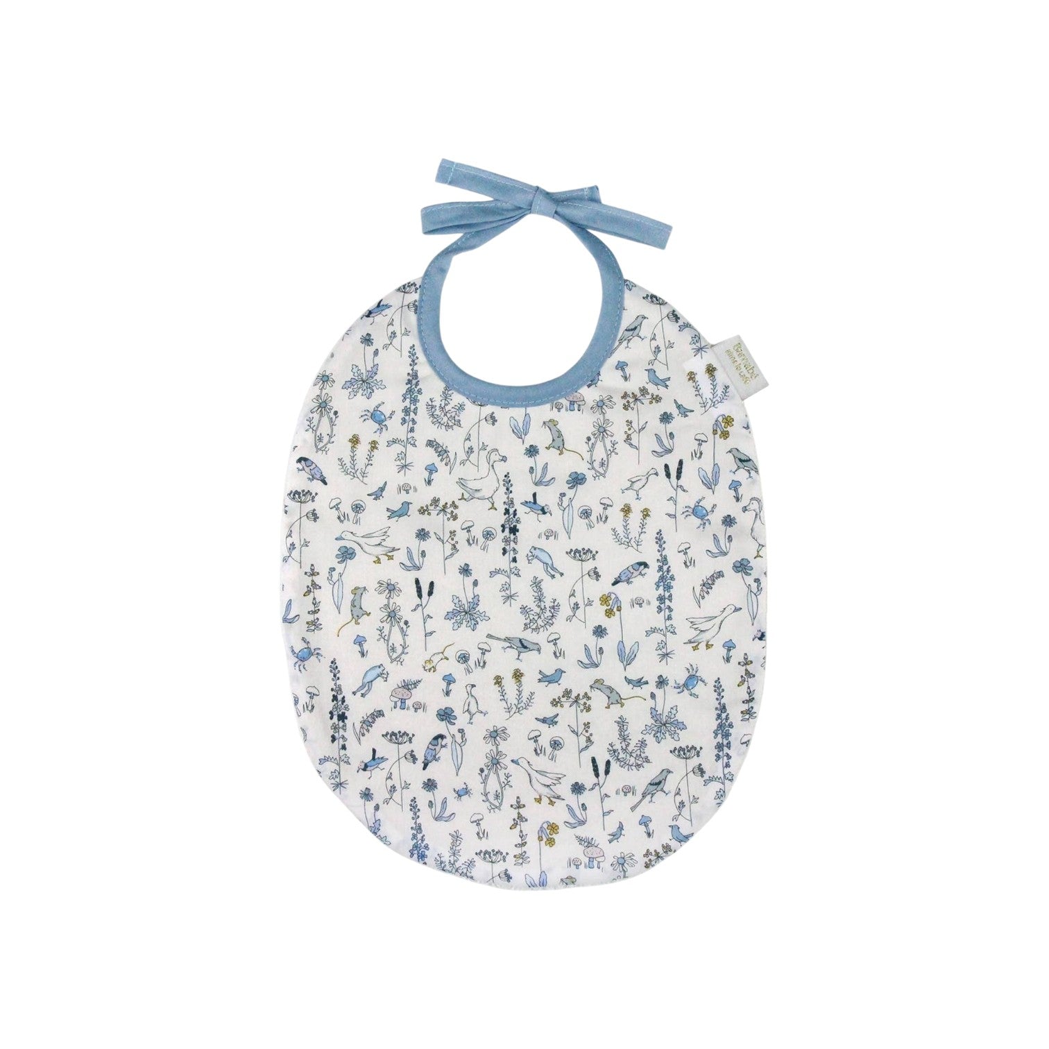 The Tiny Finch Bib Gus featuring a delicate blue and yellow floral Liberty fabric with a soft blue ribbon tie.