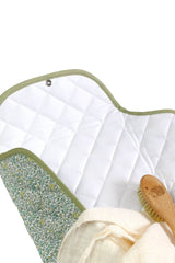 The Tiny Finch Jenny baby changing mat with white quilted fleece, green Liberty floral cotton, and metal snap button.
