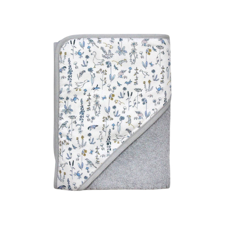 The Tiny Finch Baby Towel Gus featuring a white Liberty floral print and soft grey sponge loop fabric.