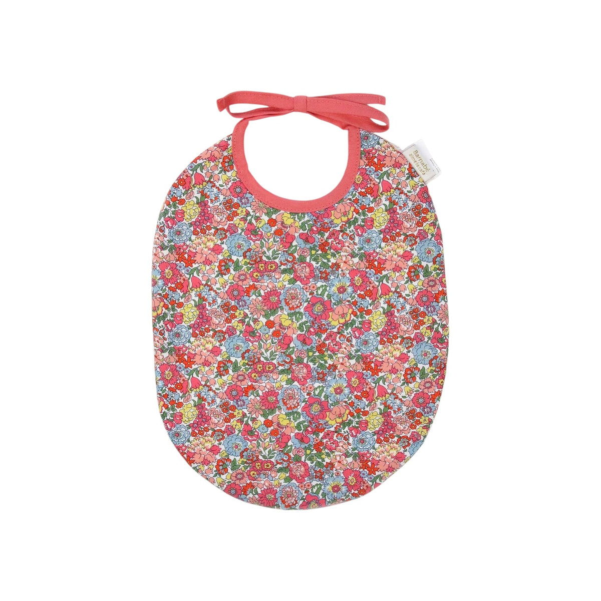 The Tiny Finch Bib Augustine featuring a colorful floral Liberty London cotton print with pink trim and tie closure.