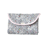 The Tiny Finch Liberty floral print travel changing mat in grey and pink, folded into a compact pouch.