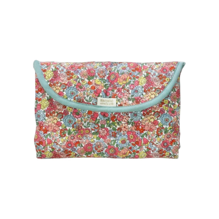 The Tiny Finch Augustine travel changing mat in a floral Liberty print cotton fabric folded into a compact pouch.
