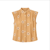 The Tiny Finch Gemma tan silk sleeveless top with white floral embroidery, pleated details, and front button closure.