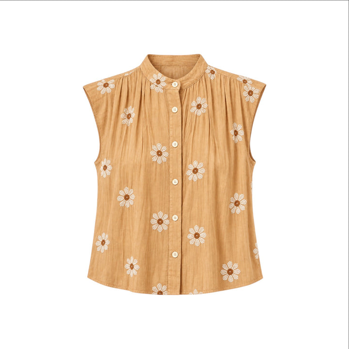 The Tiny Finch Gemma tan silk sleeveless top with white floral embroidery, pleated details, and front button closure.