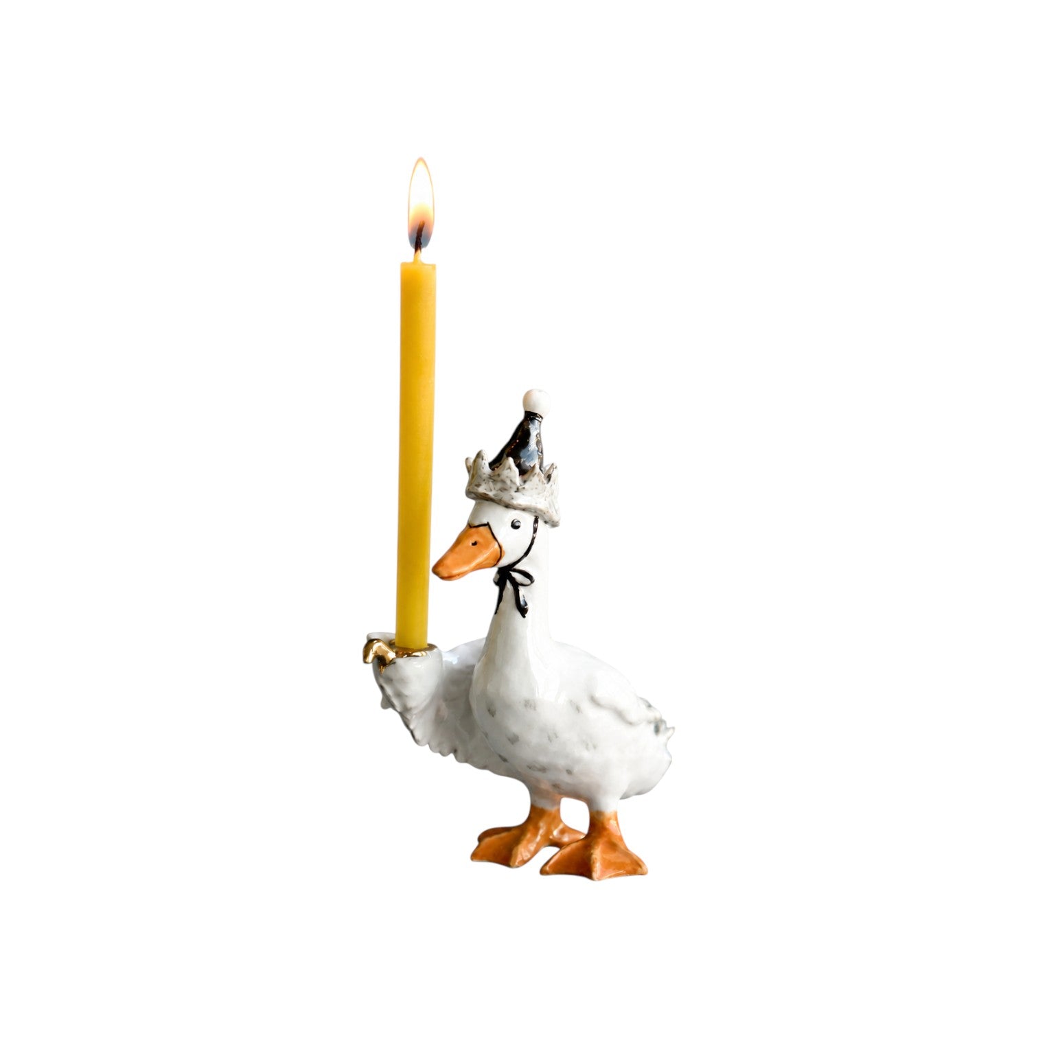 The Tiny Finch Goodnight Goose ceramic cake topper wearing a crown nightcap and holding a yellow taper candle.