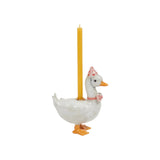 The Tiny Finch ceramic goose cake topper wearing a pink polka dot party hat and bowtie with a yellow candle