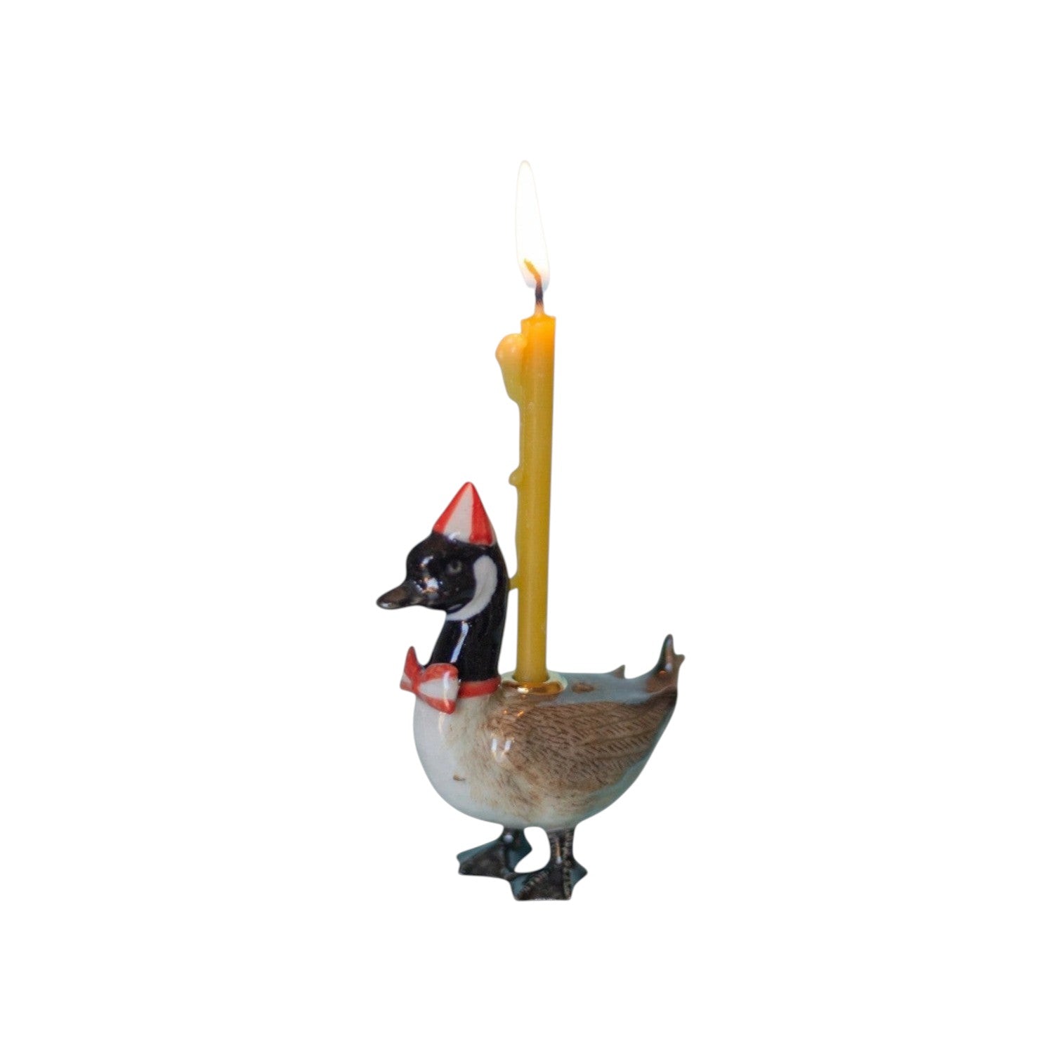 The Tiny Finch Canadian goose cake topper wearing a party hat and bow tie with a lit yellow candle on its back.