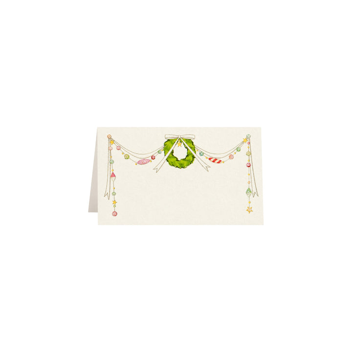 The Tiny Finch Tis the Season place cards featuring a festive wreath and gold foil ornaments on natural white paper.