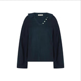 The Tiny Finch Gaia top in indigo cotton featuring a scalloped embroidered collar, V-neck, and mother-of-pearl buttons.