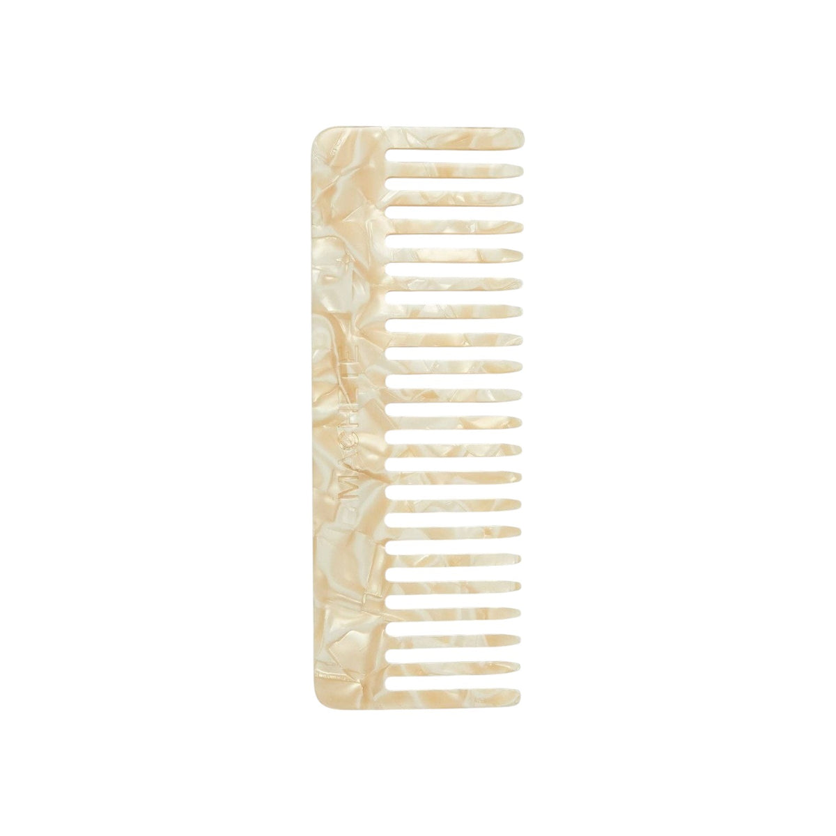The Tiny Finch ivory wide-tooth comb handcrafted from renewable Italian acetate with a marbled finish.