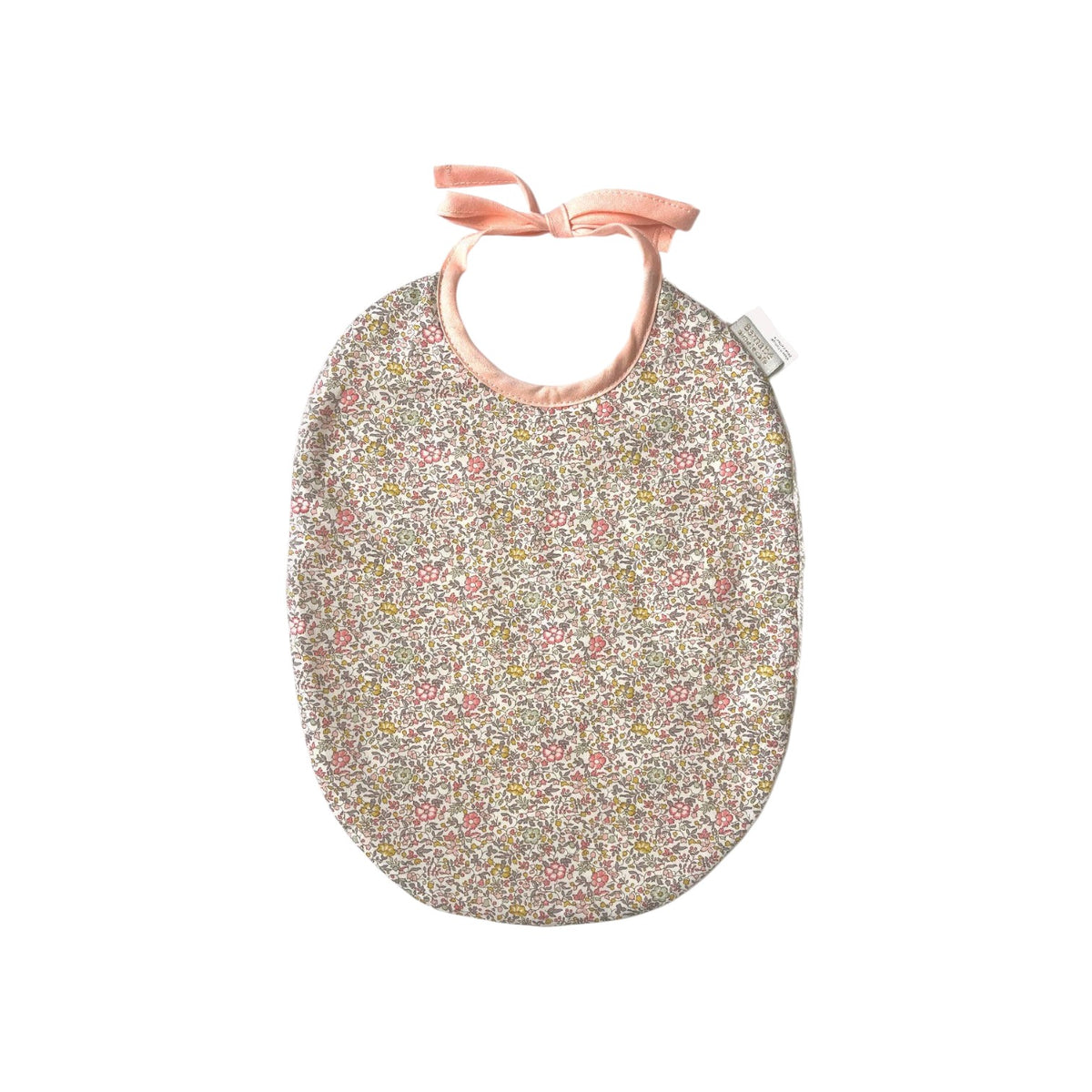 The Tiny Finch Juliette baby bib featuring a delicate floral Liberty fabric print with soft pink ribbon ties.