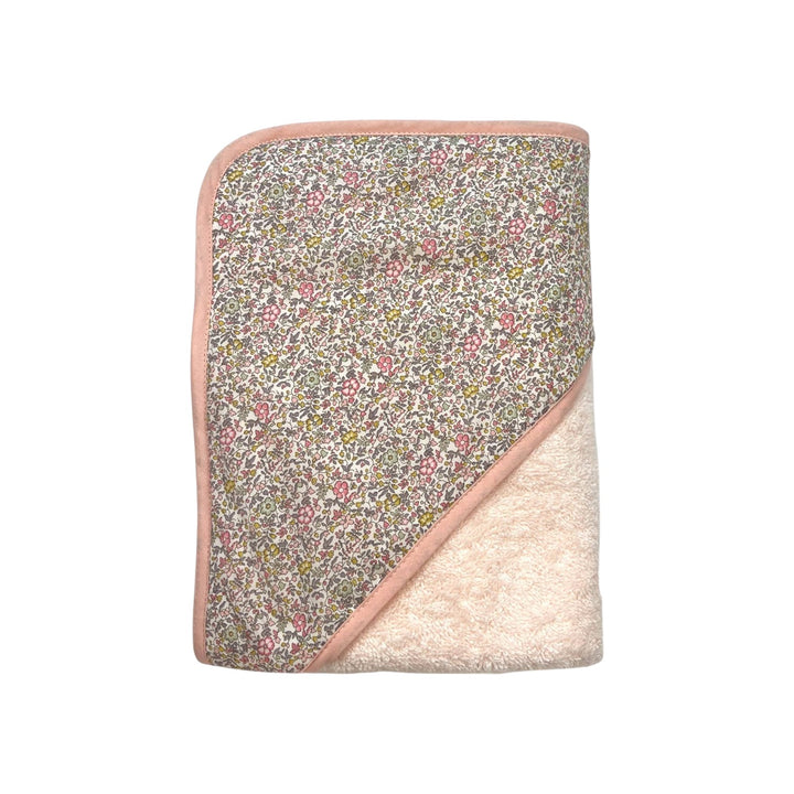 The Tiny Finch Juliette baby bath towel featuring floral Liberty fabric and soft pink sponge loop trim.