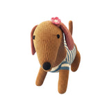 The Tiny Finch knitted dachshund plush toy in brown with a blue striped sweater and a pink cherry blossom on its ear.