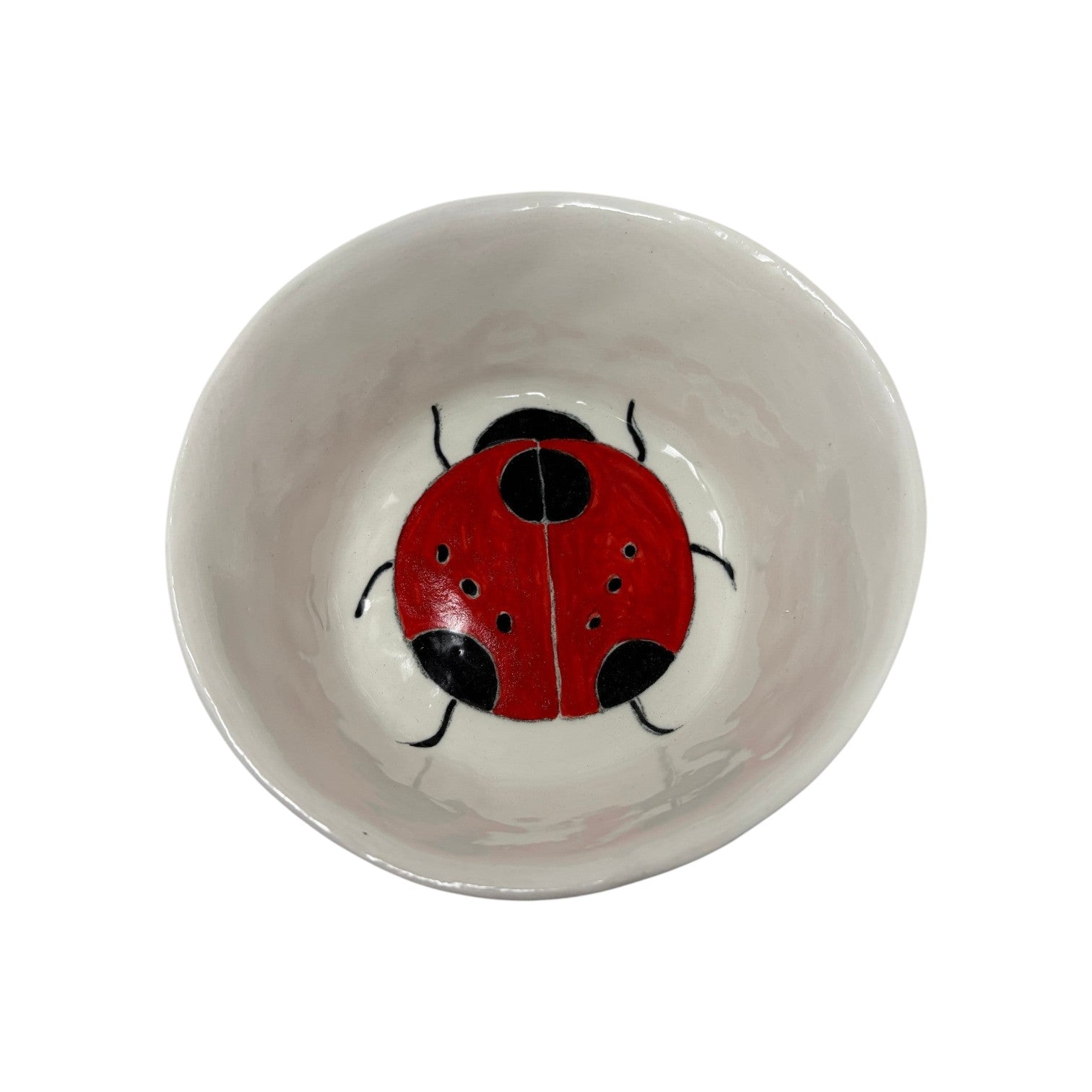 The Tiny Finch ceramic snack bowl featuring a hand-painted red and black ladybug design on a white background