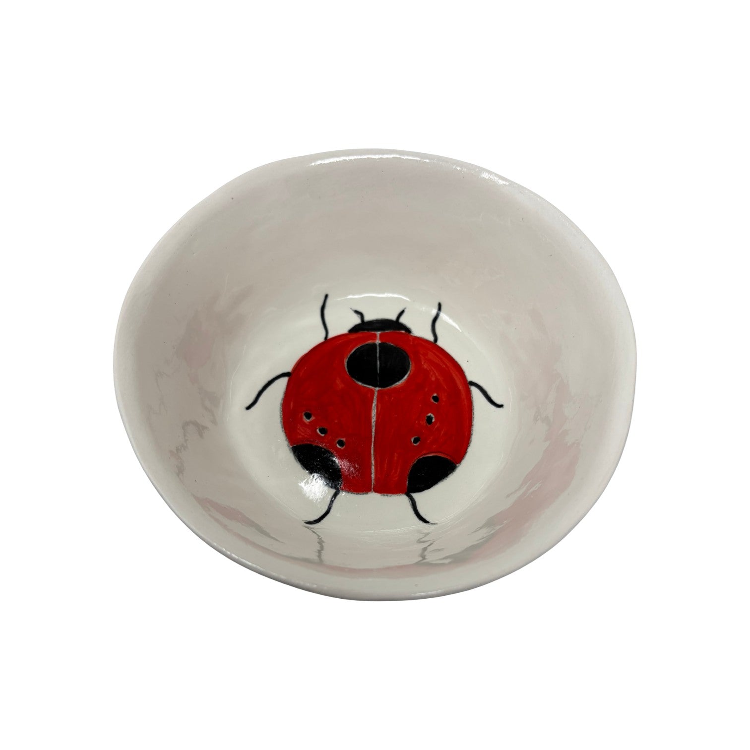 The Tiny Finch ceramic snack bowl featuring a hand-painted red and black ladybug design on a white background