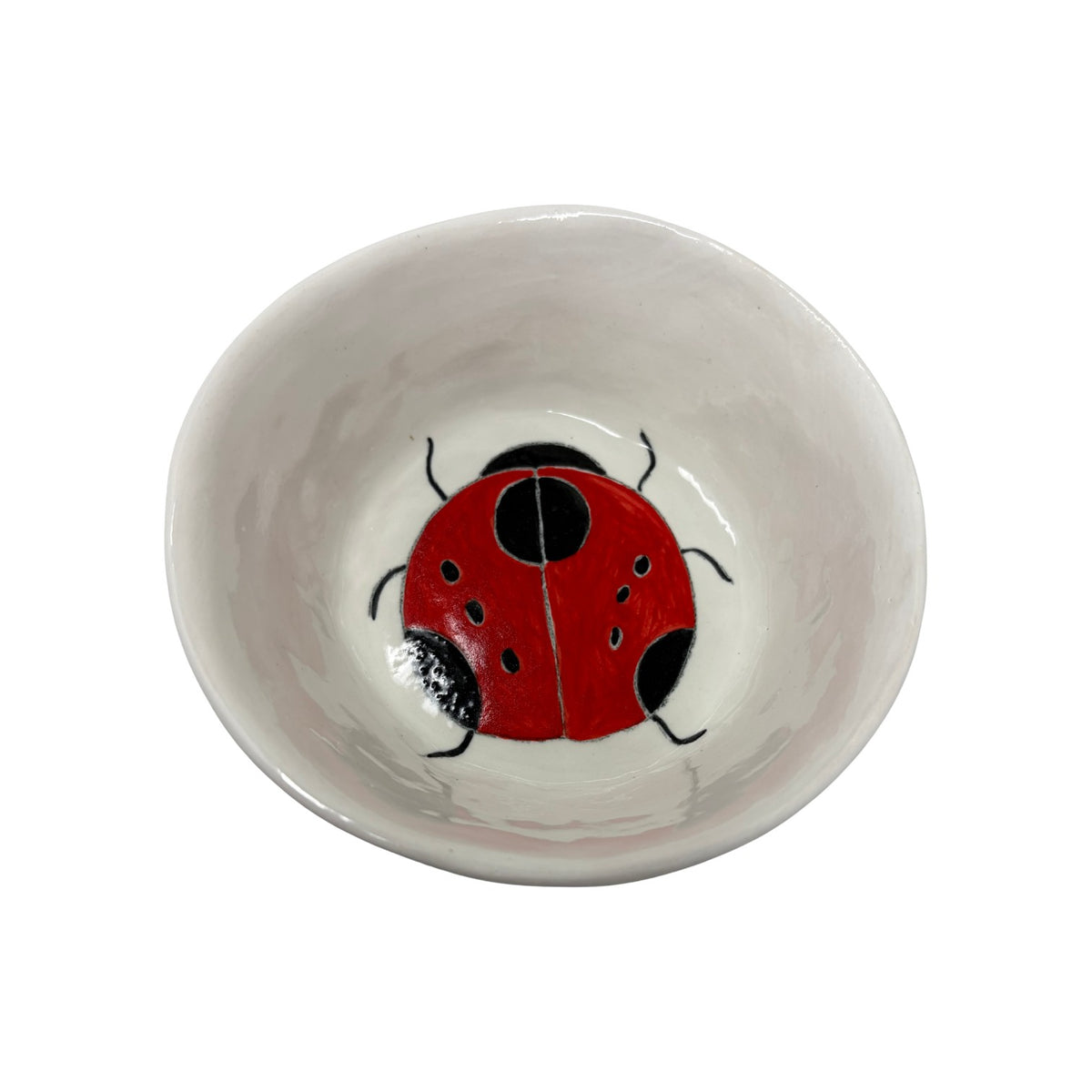 The Tiny Finch ceramic snack bowl featuring a hand-painted red and black ladybug design on a white background.