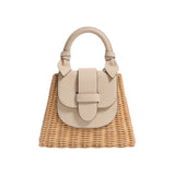 The Tiny Finch Petite Lady Latte bag in handwoven rattan with an embossed lizard leather flap and knot handle.