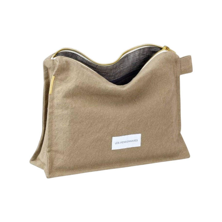 The Tiny Finch Les Pensionnaires lime green organic cotton canvas toiletry bag with a triangular shape and zipper.