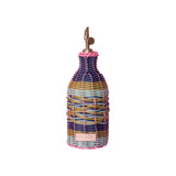 The Tiny Finch Maegen hand-woven oil pourer in pink, navy, olive, and sky blue with a retro bistro-inspired design.