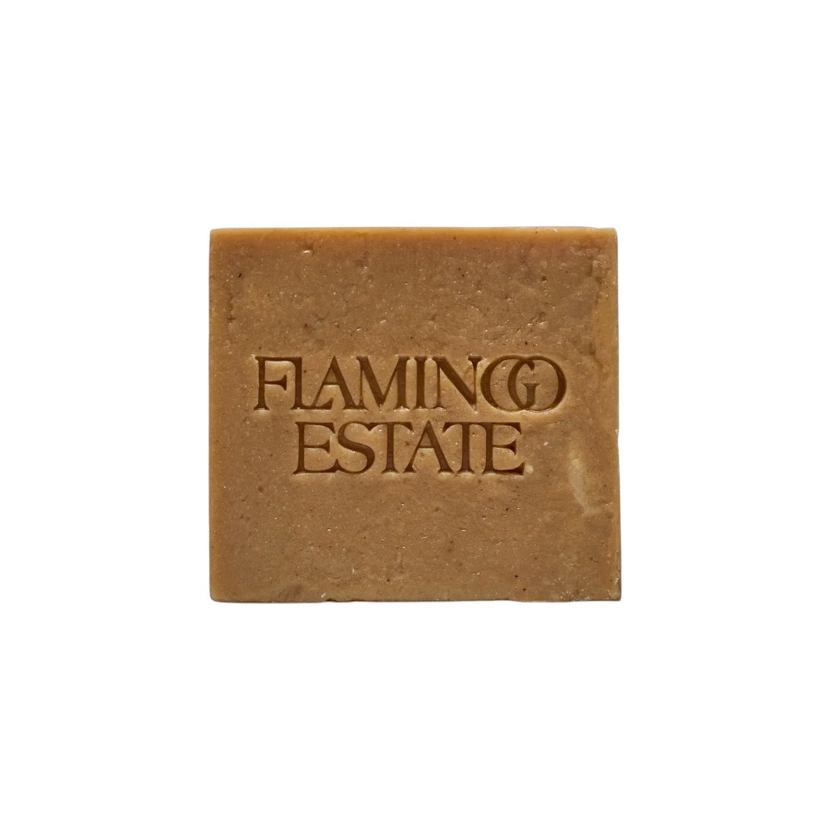 The Tiny Finch Flamingo Estate Manuka Honey Soap Brick with embossed logo, featuring hydrating shea butter and honey.