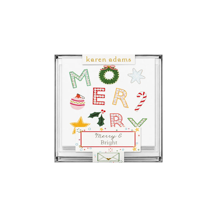 The Tiny Finch Merry holiday gift enclosure cards with hand-glittered festive icons in a clear acrylic box.