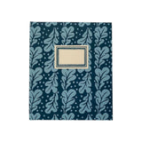 The Tiny Finch large hardback notebook in midnight blue with a patterned oak leaf design and cream front label.