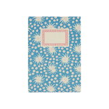 The Tiny Finch hardback notebook in Milky Way blue and old red with a patterned cover and cream rectangular label.