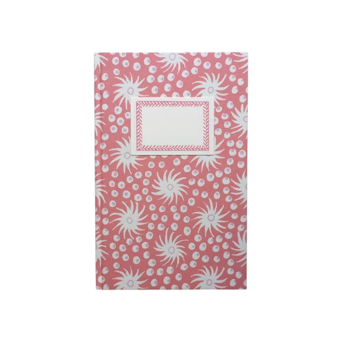 The Tiny Finch hardback notebook in pink and old red with a Milky Way star pattern and a cream rectangular label.