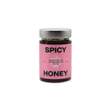 The Tiny Finch Morita Chile Spicy Honey in a glass jar with a pink label featuring Dzidzilché rainforest honey.