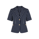 The Tiny Finch Kenny linen blazer in navy with white pinstripes, short sleeves, notched collar, and wood buttons.