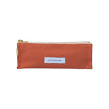 The Tiny Finch Les Pensionnaires orange organic cotton canvas pencil case with a gold zipper and rectangular label.