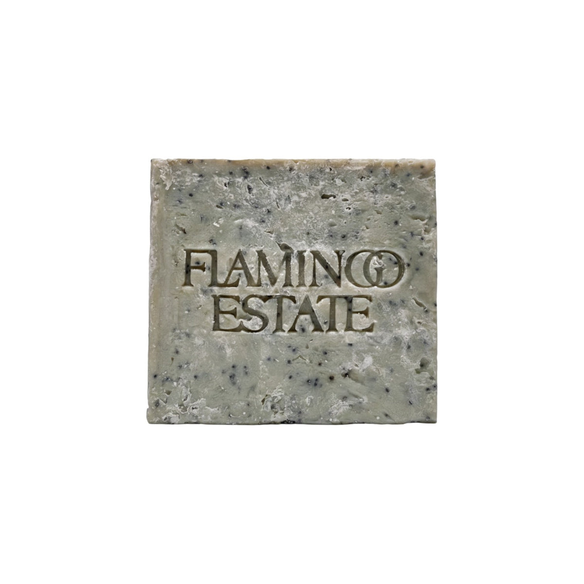 The Tiny Finch exfoliating peppermint soap brick with a textured grey surface and embossed Flamingo Estate logo