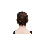The Tiny Finch petite 3-inch gold-plated recycled brass French hair pin styled in a woman's brown hair bun