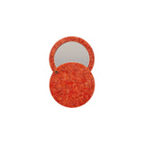 The Tiny Finch poppy red circular pocket mirror made from handmade Italian acetate with a swivel opening mechanism.