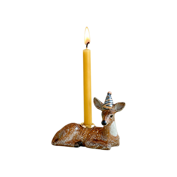 The Tiny Finch porcelain deer cake topper with a yellow and blue striped party hat and gold candle holder