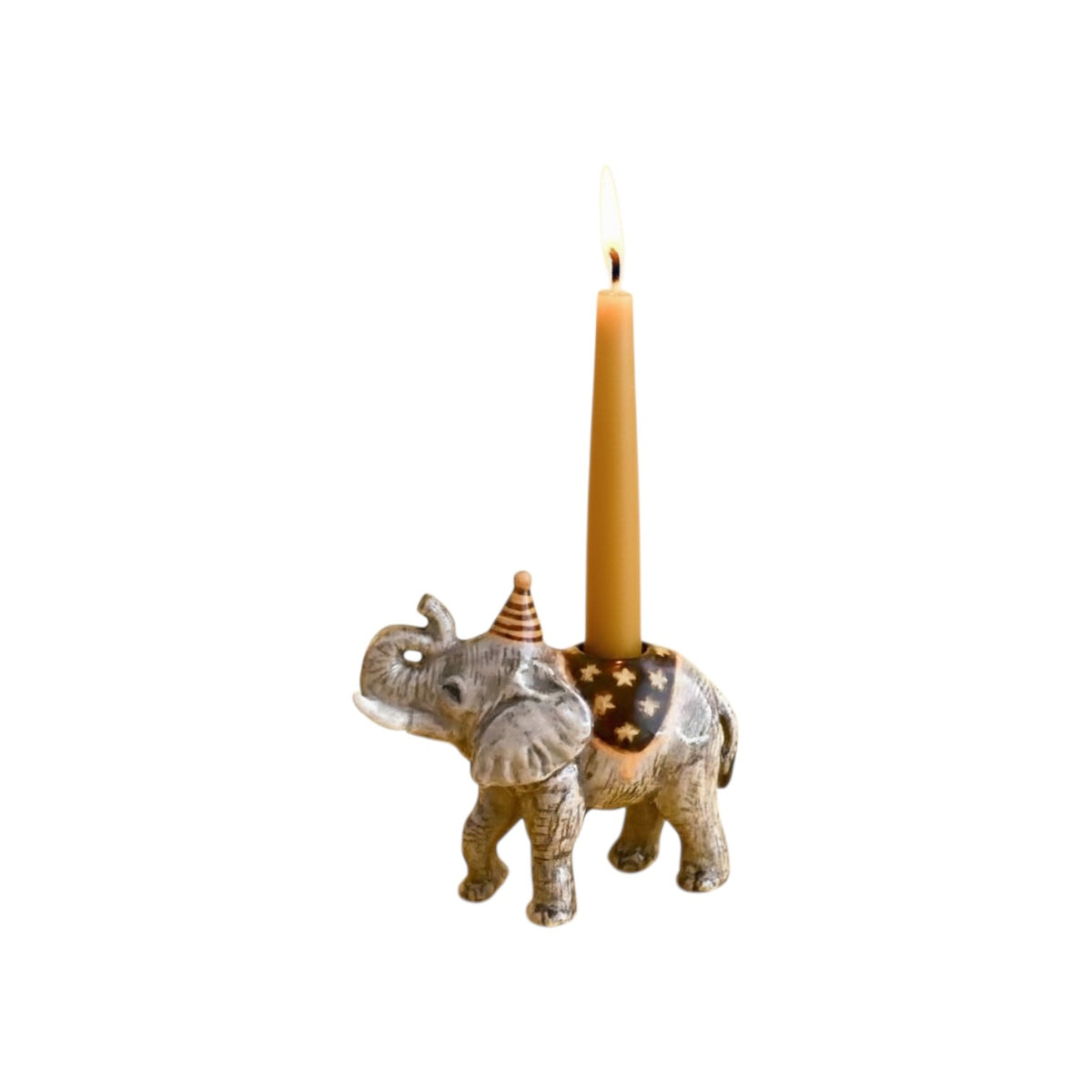 The Tiny Finch hand-painted porcelain elephant cake topper with a party hat and lit birthday candle
