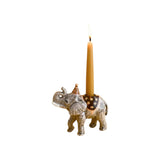 The Tiny Finch hand-painted porcelain elephant cake topper with a party hat and lit birthday candle