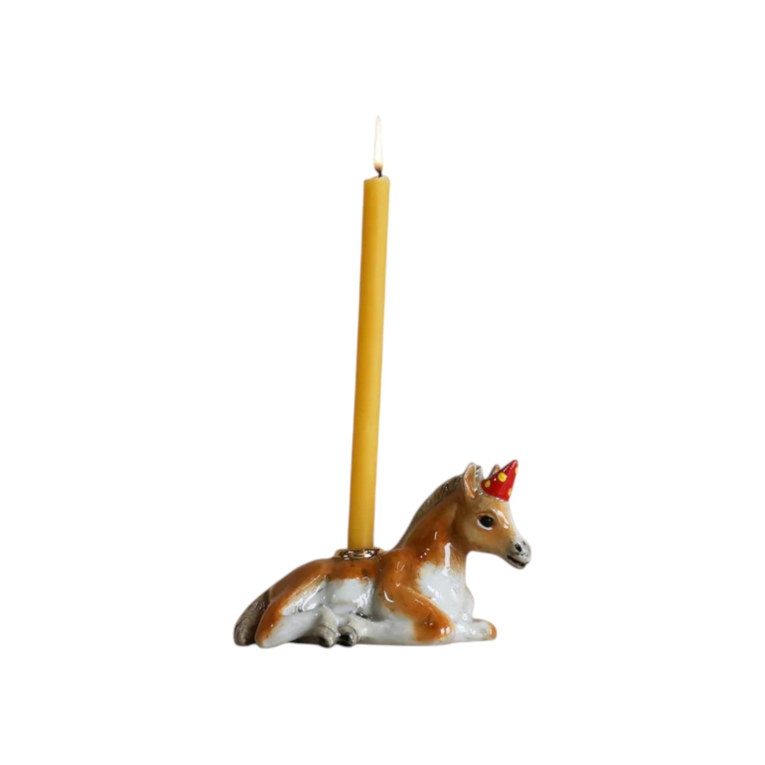 The Tiny Finch porcelain horse cake topper with a party hat holding a yellow birthday candle