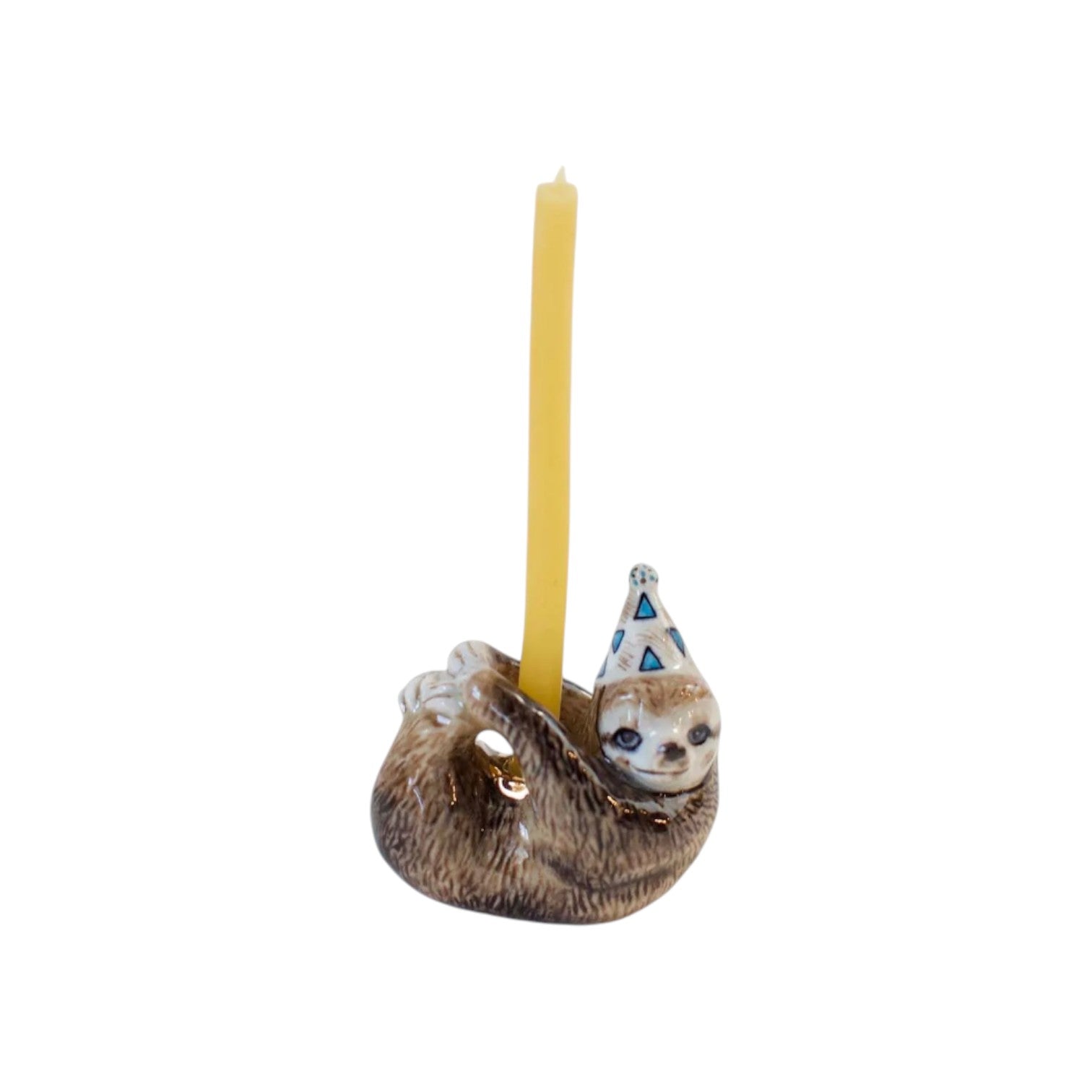 The Tiny Finch porcelain sloth cake topper wearing a party hat with a yellow candle, hand-painted in brown tones.