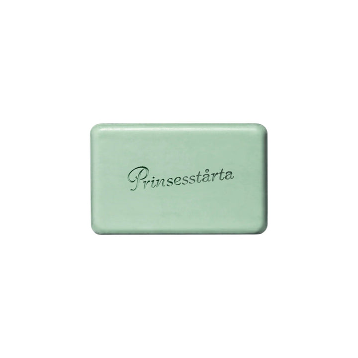 The Tiny Finch Prinsesstarta Milk Bar in a soft sage green, featuring a smooth, rectangular shape with embossed text.