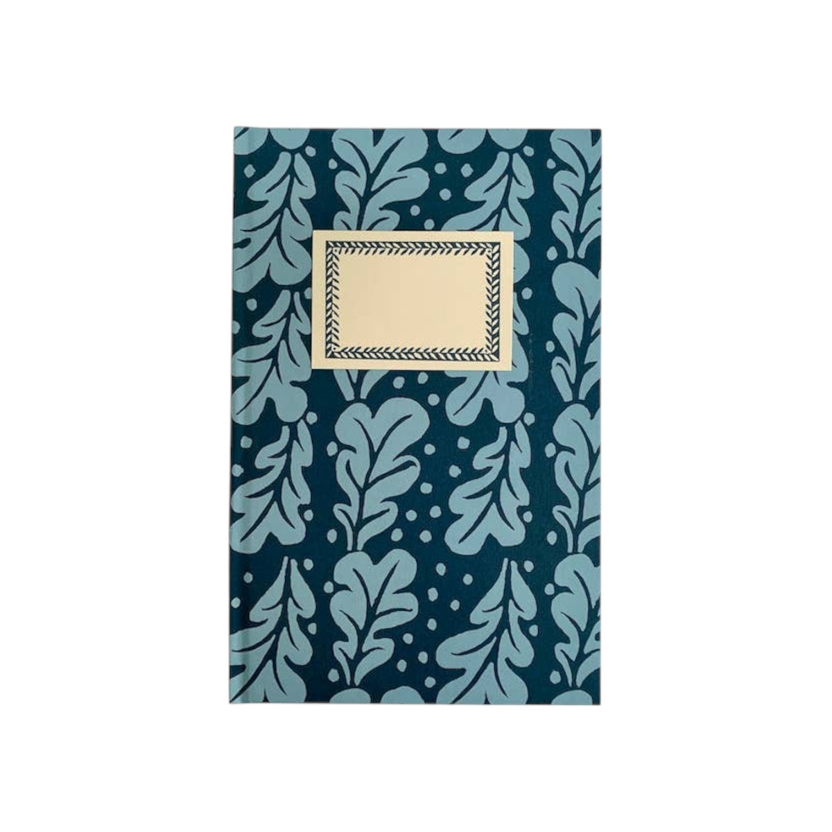 The Tiny Finch Quercus Midnight hardback notebook with a dark blue oak leaf pattern and a cream front label.