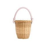 The Tiny Finch Jane Blush Bag, a handwoven rattan basket bag with a sculptural cloud blue lizard-embossed top handle.