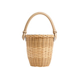 The Tiny Finch Jane Latte handwoven rattan basket bag with a lizard-embossed leather top handle and magnetic closure.
