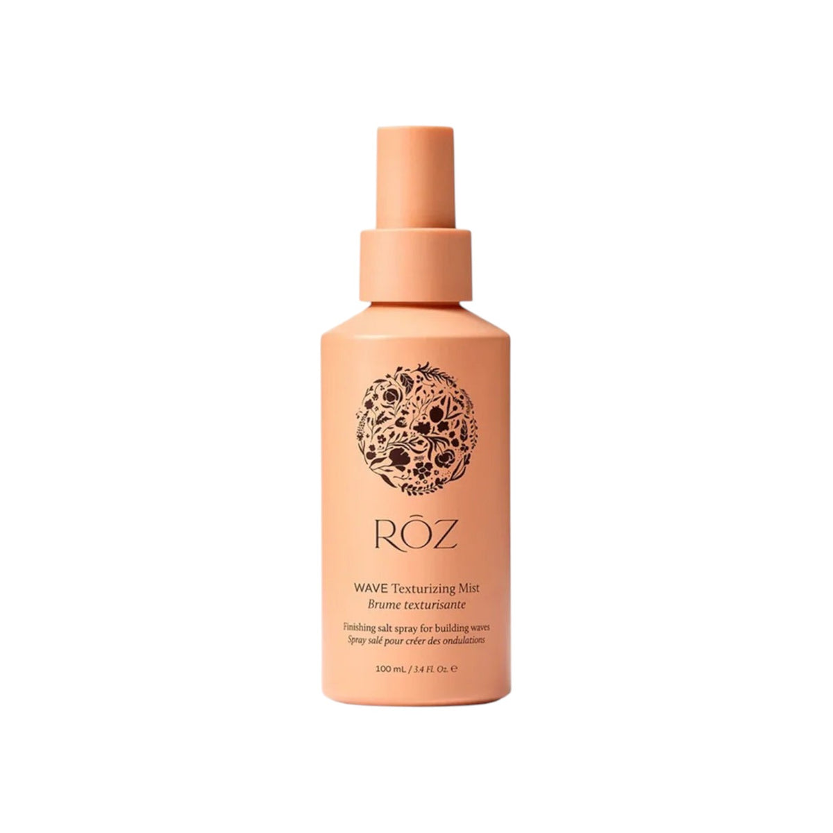 The Tiny Finch ROZ Wave Texture Mist in a peach-colored spray bottle for defining lived-in hair waves.