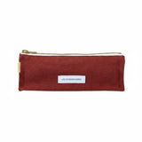 The Tiny Finch Les Pensionnaires rust organic cotton canvas pencil case with a gold zipper and white brand label.
