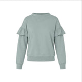 The Tiny Finch Kismet sweatshirt in sage green cotton terry with sculptural ruffle sleeves and ribbed trim.