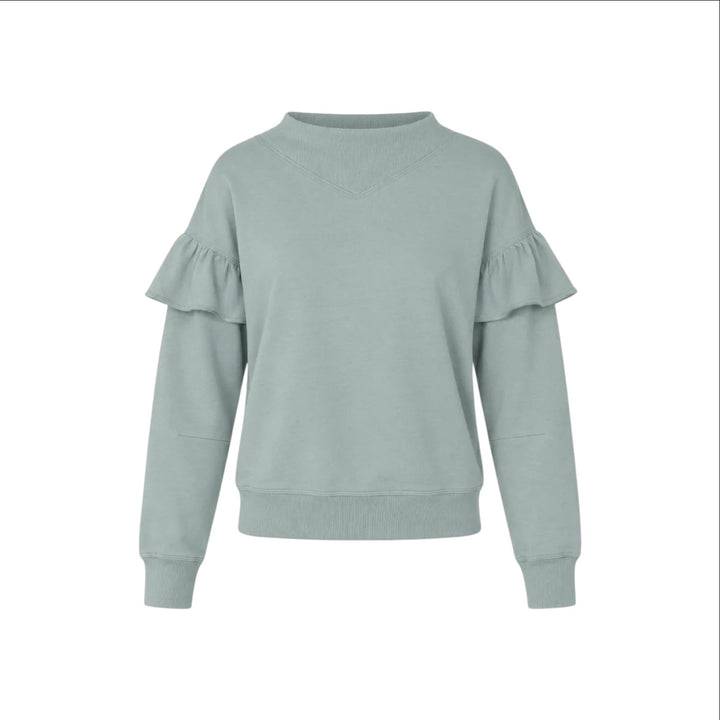 The Tiny Finch Kismet sweatshirt in sage green cotton terry with sculptural ruffle sleeves and ribbed trim.